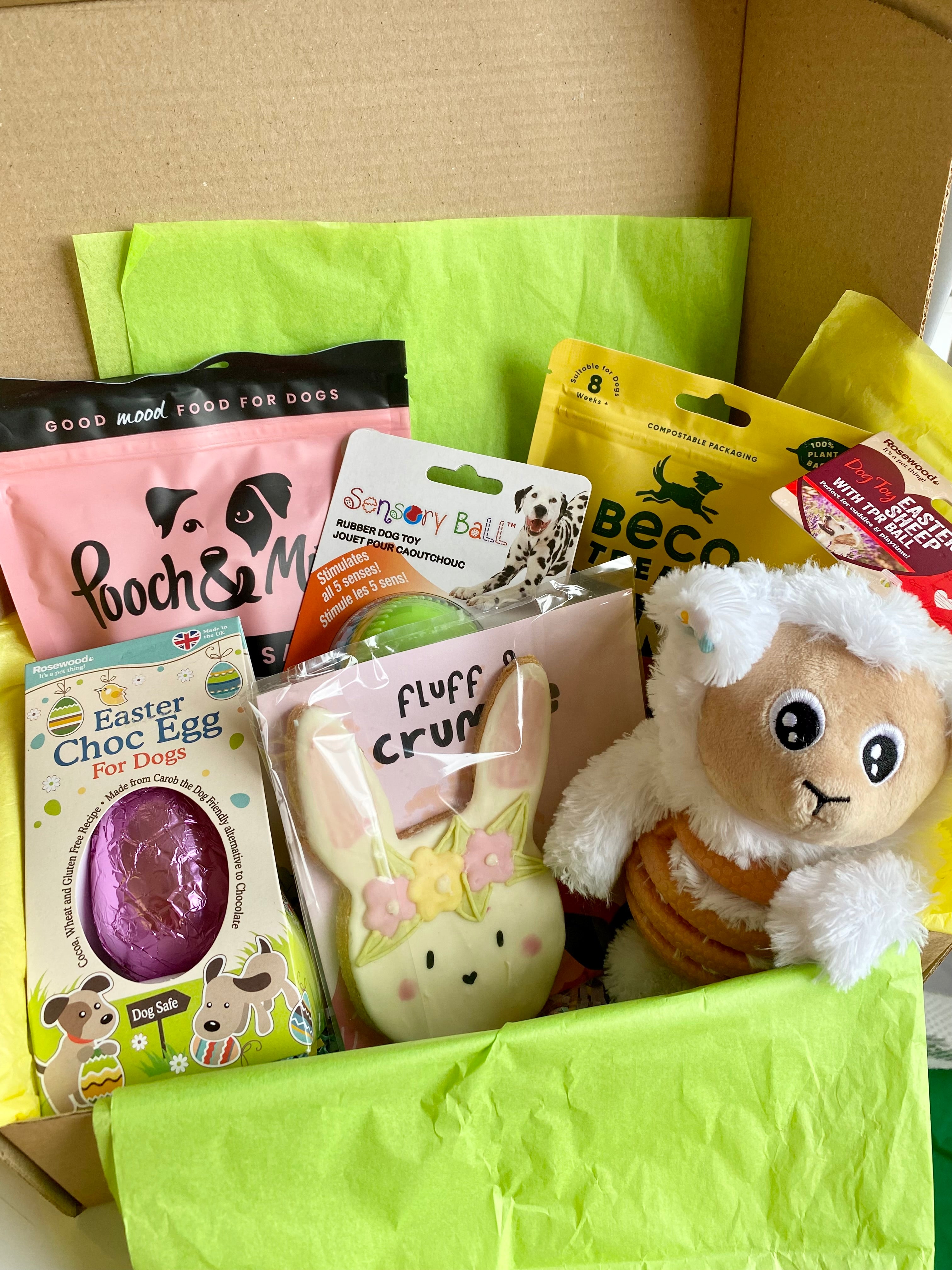 Open BarkyBox filled with Easter dog treats, plush toys, and natural snacks like Beco and Pooch & Mutt”

