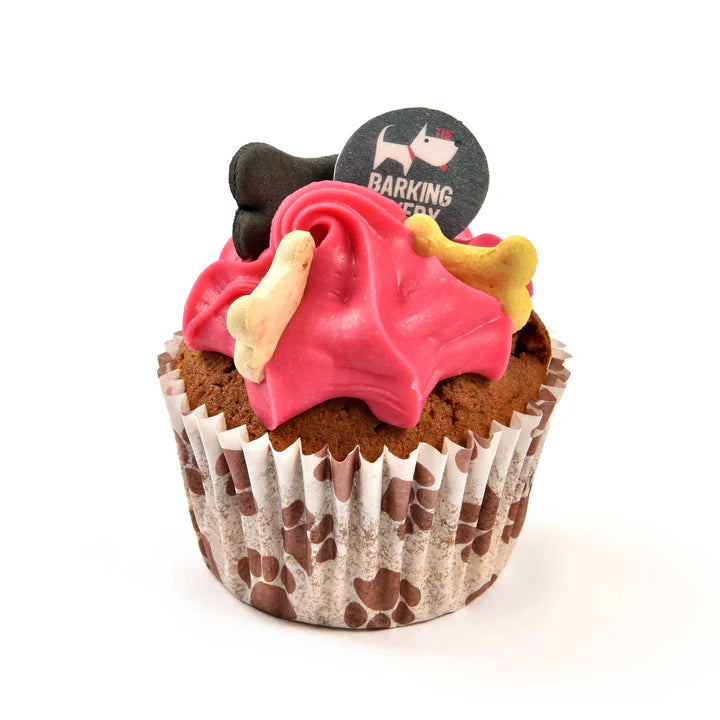 Pink Woofin dog cupcake with bright pink frosting, bone biscuits, and a Barking Bakery topper