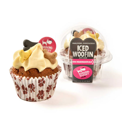 A vanilla iced doggy cupcake with a swirl of frosting, a dog bone decoration, and an edible disc, presented in a paw print wrapper. The product is packaged in a clear recyclable pod with branding labels.